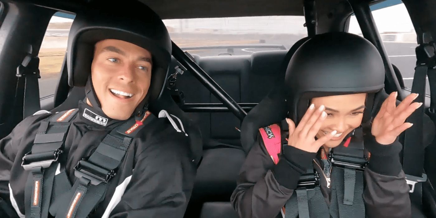 Jenn Tran with her hands in front of her face, sitting next to Aaron in a race car in 'The Bachelorette' Season 21, Episode 3.