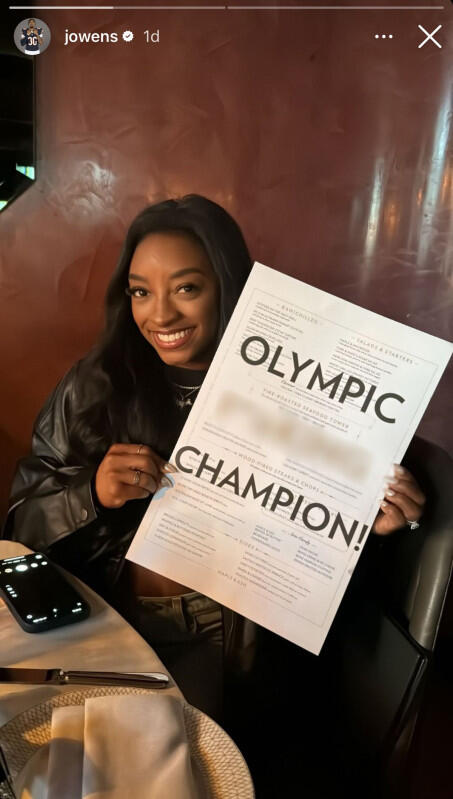 Simone Biles poses for a photo in Chicago restaurant Maple & Ash