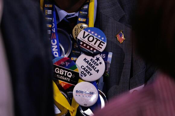 A delegate wears pins supporting Kamala Harris