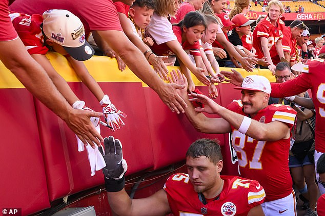 Kelce high-fives his adoring fans after the game against the Detroit Lions at Arrowhead