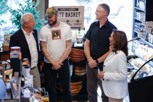 US Vice President and 2024 Democratic presidential candidate Kamala Harris (R), owner of "Volume One & The Local Store" Nick Meyer (2R), singer Justin Vernon of Bon Iver (2L) and Harris's running mate Minnesota Governor Tim Walz (L) talk inside the store in Eau Claire, Wisconsin, August 7, 2024. (Photo by KAMIL KRZACZYNSKI / AFP) (Photo by KAMIL KRZACZYNSKI/AFP via Getty Images)