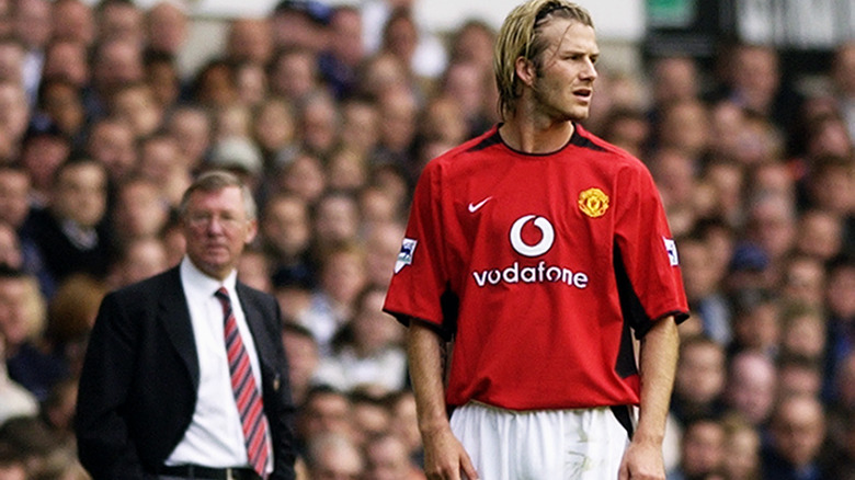 David Beckham on soccer field near Alex Ferguson