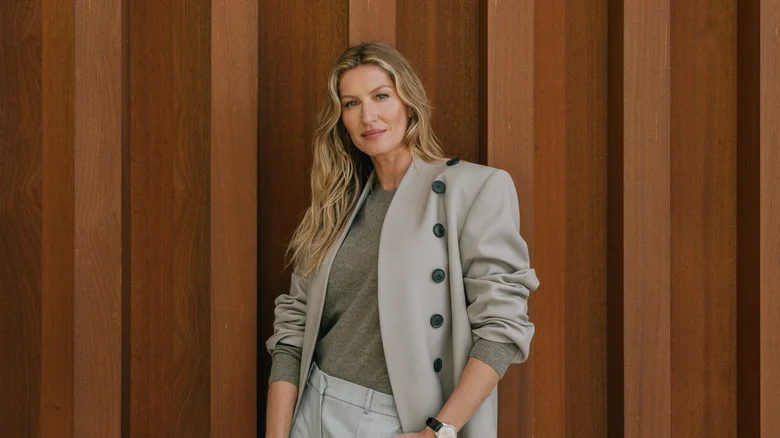 Gisele Bundchen posing in front of a textured wall