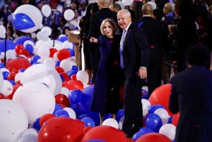 Gov. Tim Walz, right, and Gwen Walz, left, onstage at United Center in Chicago on the final night of the Democratic National Convention on Aug. 22, blue carolina herrera bow dress