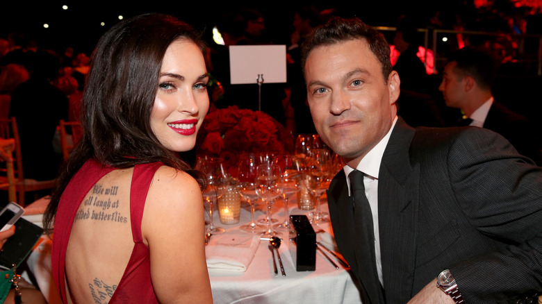 Megan Fox and Brian Austin Green sitting at a table