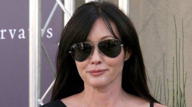 Shannen Doherty looking serious and wearing sunglasses