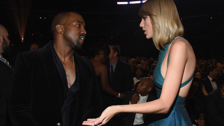 Taylor Swift talking to Kanye West at an event