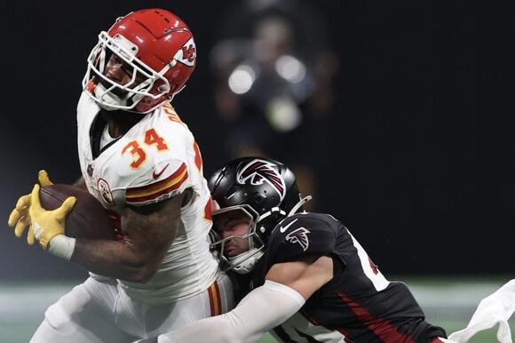 Kansas City Chiefs running back Samaje Perine is tackled by Atlanta Falcons linebacker Troy Andersen.