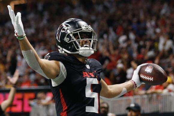 Falcons wide receiver Drake London celebrates after catching a touchdown.