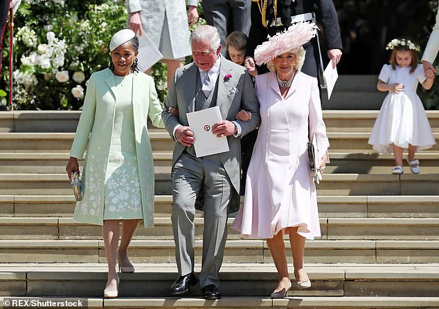 Doria linking arms with King Charles at her daughter's wedding in May 2018