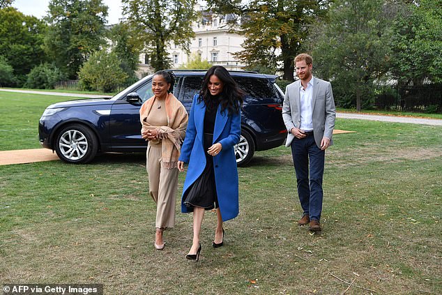 Doria accompanying Meghan and Harry to an event marking the launch of a Grenfell Tower cookbook in September 2018