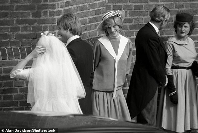 Diana smiling at her close friend as they walk by following their wedding ceremony