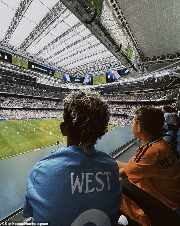 The proud mom also snapped a photo of Saint watching the game while wearing a custom jersey with his surname on the back and sitting next to his friend